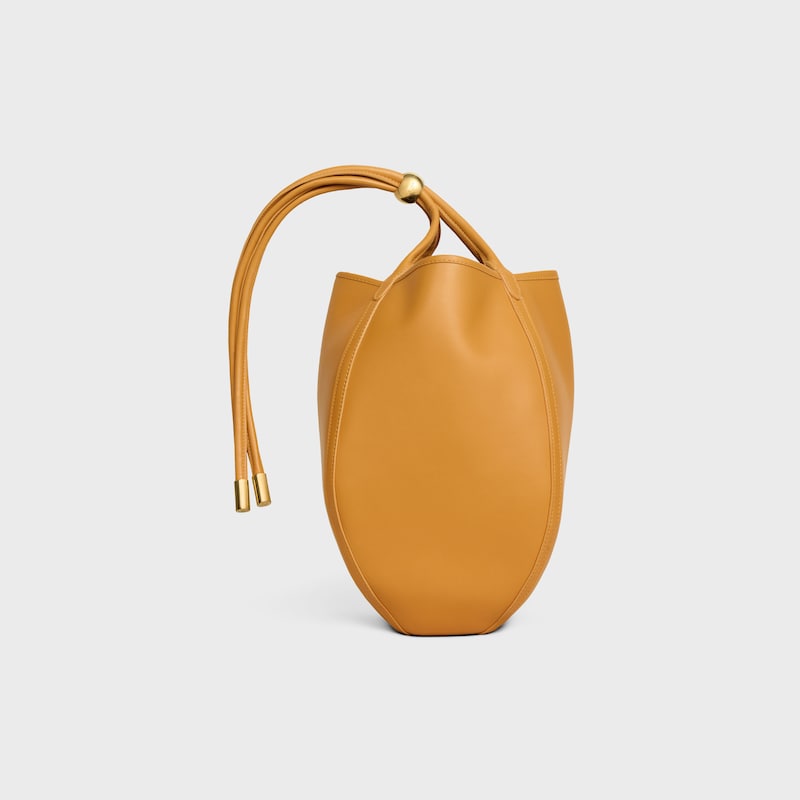 SMALL DROP BUCKET IN SUPPLE SMOOTH CALFSKIN - MARIGOLD - CROSS-BODY BAGS - 1 | CELINE